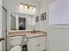 Bathroom featuring tub-shower, large mirror, and toilet; plenty of vanity counter space at 2875 Cooper Creek Dr, Henderson, NV 89074