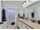 A well-lit bathroom featuring a double sink vanity and a shark themed shower curtain at 2875 Cooper Creek Dr, Henderson, NV 89074