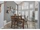 Cozy dining area with stylish light fixtures, wine rack and plantation shutters offers a great place to entertain at 2875 Cooper Creek Dr, Henderson, NV 89074