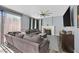 Comfortable living room features a fireplace, large windows, and cozy seating, perfect for relaxing with Gathering and friends at 2875 Cooper Creek Dr, Henderson, NV 89074