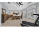 Spacious main bedroom features a treadmill, white walls, modern furniture, and French doors at 2875 Cooper Creek Dr, Henderson, NV 89074
