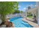 Inviting backyard with a refreshing pool, spa, and serene landscaping, perfect for outdoor entertaining and relaxation at 2875 Cooper Creek Dr, Henderson, NV 89074