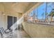 Relaxing balcony with seating and views of the surrounding community with its lush landscaping and palm trees at 2975 Bluegrass Ln # 412, Henderson, NV 89074