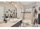 Well-lit bathroom featuring a tub-shower combo with tile surround, vanity with a stylish sink, and modern fixtures at 2975 Bluegrass Ln # 412, Henderson, NV 89074