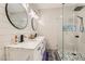 Elegant bathroom featuring a double vanity, modern fixtures, sleek mirrors, and a glass-enclosed shower at 2975 Bluegrass Ln # 412, Henderson, NV 89074