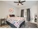 Comfortable bedroom with a floral-patterned bed, soft lighting, large window, and cozy rug at 2975 Bluegrass Ln # 412, Henderson, NV 89074