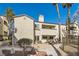Charming condo building with stucco exterior, tile roof, and mature landscaping in a gated community at 2975 Bluegrass Ln # 412, Henderson, NV 89074