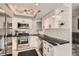 Modern kitchen featuring stainless steel appliances, white cabinetry, black countertops, and ample lighting at 2975 Bluegrass Ln # 412, Henderson, NV 89074