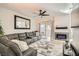 Cozy living room featuring a large sectional, fireplace, and access to a balcony with neighborhood views at 2975 Bluegrass Ln # 412, Henderson, NV 89074