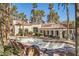 Community pool area featuring a hot tub, lounge chairs, and lush palm trees at 2975 Bluegrass Ln # 412, Henderson, NV 89074