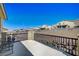 Wide-angle view of balcony with black metal railings overlooking neighborhood and clear blue sky at 352 Sidewheeler St, Henderson, NV 89012