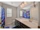 Bathroom featuring double sinks, cabinets, and a playful shower curtain at 352 Sidewheeler St, Henderson, NV 89012