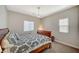 This bedroom has a sleigh bed, bedside table, and two windows with shades at 352 Sidewheeler St, Henderson, NV 89012