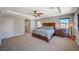 Spacious bedroom boasts neutral colors, a ceiling fan, and large windows for plenty of light at 352 Sidewheeler St, Henderson, NV 89012