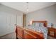 Cozy bedroom showcases a wooden sleigh bed, a sliding door closet, and a warm atmosphere at 352 Sidewheeler St, Henderson, NV 89012