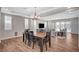 Dining area open to the living room with coffered ceilings and wood look tile flooring at 352 Sidewheeler St, Henderson, NV 89012