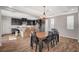 Spacious dining area with a wooden table and chairs illuminated by a chandelier at 352 Sidewheeler St, Henderson, NV 89012