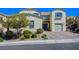 Charming two-story home featuring desert landscaping, a brick driveway, and blue shutters at 352 Sidewheeler St, Henderson, NV 89012