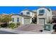 Attractive home boasts a two-car garage, well-maintained landscaping, and brick driveway at 352 Sidewheeler St, Henderson, NV 89012