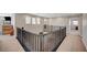 Upstairs hallway with carpet and railing that overlooks the living room at 352 Sidewheeler St, Henderson, NV 89012