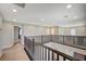 Upstairs hallway with carpeting and railing overlooking entry at 352 Sidewheeler St, Henderson, NV 89012