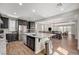 View of kitchen featuring stainless steel appliances, dark cabinets, and an island with a granite countertop at 352 Sidewheeler St, Henderson, NV 89012