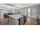 Open kitchen with granite island, stainless steel appliances, and breakfast bar seating at 352 Sidewheeler St, Henderson, NV 89012