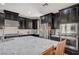 Well-equipped kitchen with stainless steel appliances, dark cabinetry, and granite countertops at 352 Sidewheeler St, Henderson, NV 89012
