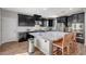 Modern kitchen with stainless steel appliances, dark cabinets, and a large kitchen island at 352 Sidewheeler St, Henderson, NV 89012