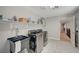 Well-equipped laundry room with sink, storage, and modern washer/dryer at 352 Sidewheeler St, Henderson, NV 89012