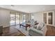 Inviting living room with wood floors, sliding glass door and comfortable gray sofa at 352 Sidewheeler St, Henderson, NV 89012