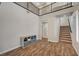 Bright, open living space with wood tile floors and staircase access at 352 Sidewheeler St, Henderson, NV 89012