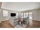 Stylish living room featuring wood floors, gray sofas, and sliding glass door to the outside at 352 Sidewheeler St, Henderson, NV 89012