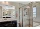 Glass-enclosed shower in the main bathroom with a built-in seat, and a double vanity at 352 Sidewheeler St, Henderson, NV 89012