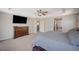 Large main bedroom with decorative ceiling fan, dresser, and view of the ensuite bath at 352 Sidewheeler St, Henderson, NV 89012