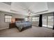 This spacious main bedroom boasts tray ceilings, large windows, and access to a private balcony at 352 Sidewheeler St, Henderson, NV 89012