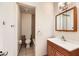 Bathroom featuring tiled floors and walls, wood vanity, and a vanity mirror at 3577 Wayne Cir, Las Vegas, NV 89121