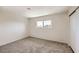 Bedroom featuring carpet floors, a closet, and bright window with palm tree view at 3577 Wayne Cir, Las Vegas, NV 89121
