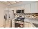 Modern kitchen with stainless steel appliances, stylish backsplash, and granite countertops at 3577 Wayne Cir, Las Vegas, NV 89121