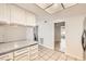 Kitchen featuring white cabinets and granite countertops, with tile flooring at 3577 Wayne Cir, Las Vegas, NV 89121