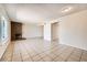 Open-concept living room with a brick fireplace, tiled floors, and plenty of natural light creates an inviting atmosphere at 3577 Wayne Cir, Las Vegas, NV 89121