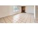 Bright living room featuring tiled floors, a brick fireplace, and a large window offering abundant natural light at 3577 Wayne Cir, Las Vegas, NV 89121