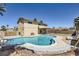 Backyard featuring a large in-ground pool, lounge chairs, and a covered patio area, perfect for outdoor relaxation and entertainment at 3577 Wayne Cir, Las Vegas, NV 89121