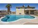 Large, private pool area with a diving board, lush landscaping, and outdoor seating areas at 3577 Wayne Cir, Las Vegas, NV 89121