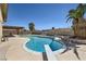 Inviting pool with diving board surrounded by lush landscaping and a covered patio area at 3577 Wayne Cir, Las Vegas, NV 89121