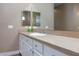 Bathroom vanity featuring a granite countertop, white cabinets, and dual mirrors for added convenience at 3662 Riley Ann Ave, Las Vegas, NV 89139