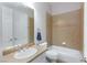Bathroom featuring vanity with mirror, tile floors, toilet and tub with tiled walls at 3662 Riley Ann Ave, Las Vegas, NV 89139