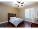 Bedroom featuring a ceiling fan, plantation shutters, and dark hardwood floors at 3662 Riley Ann Ave, Las Vegas, NV 89139