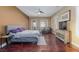 Well-lit bedroom with wood floors, ceiling fan, shutters and seating area at 3662 Riley Ann Ave, Las Vegas, NV 89139