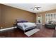 Spacious bedroom featuring dark hardwood floors, a comfortable seating area and modern blinds at 3662 Riley Ann Ave, Las Vegas, NV 89139